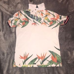 it’s a white button down shirt with leaves, clean